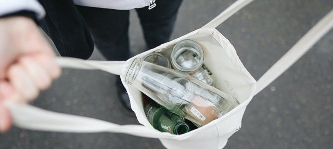 Little Things Article Image 01 someone holding open a bag of glass bottles