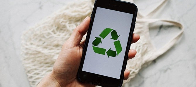 Little Things Article Image 03 someone holding a smartphone with the recycling logo
