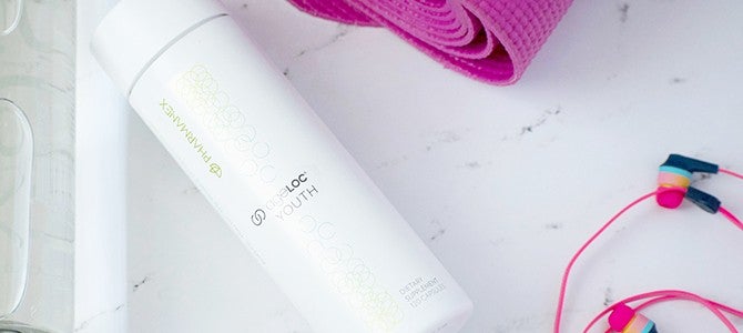 gene expression article - image 01 bottle of ageLOC Youth by Pharmanex with exercise gear - Nu Skin